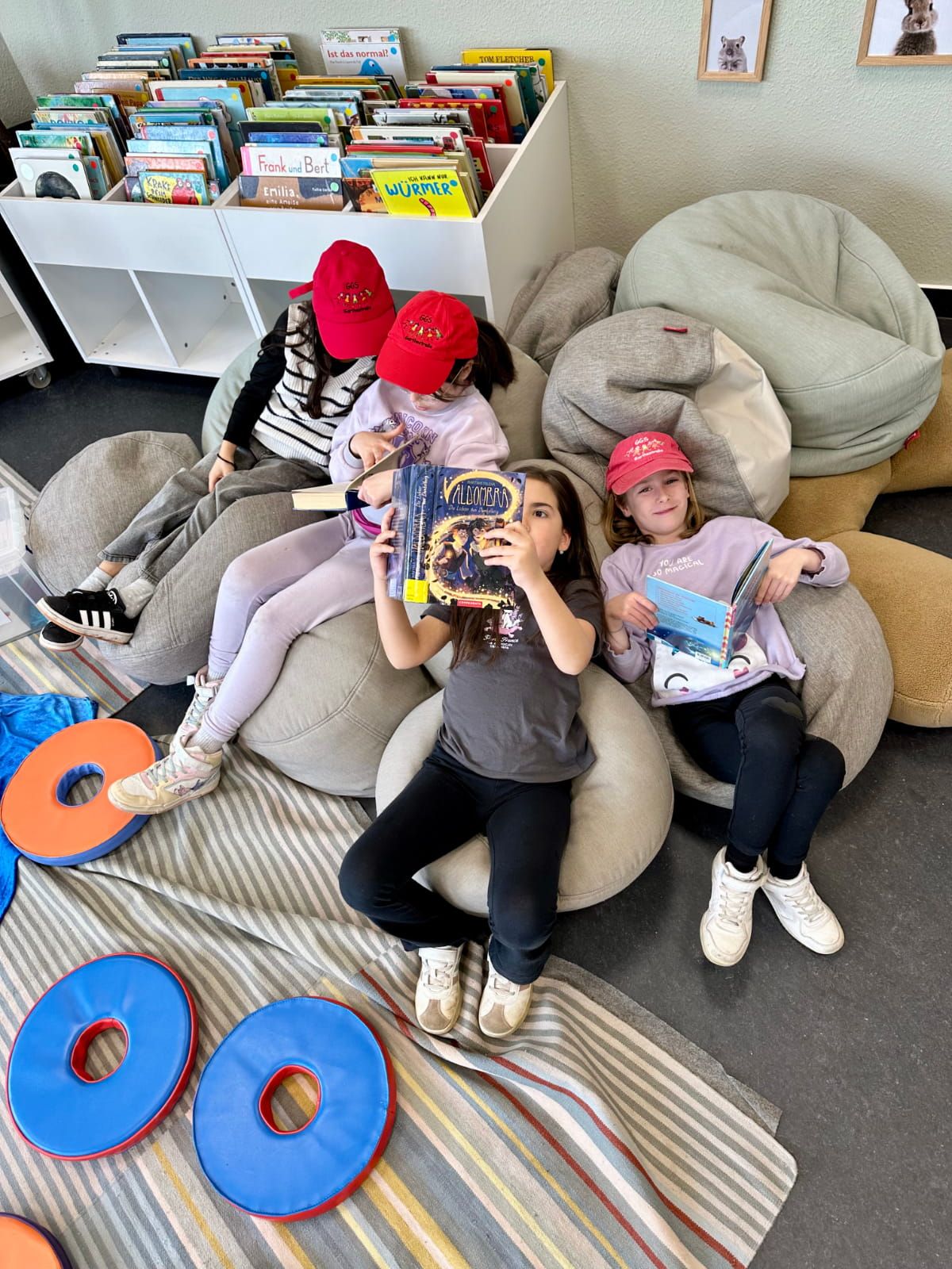 vier Kinder lesen Bücher in einer Sitzsatzecke