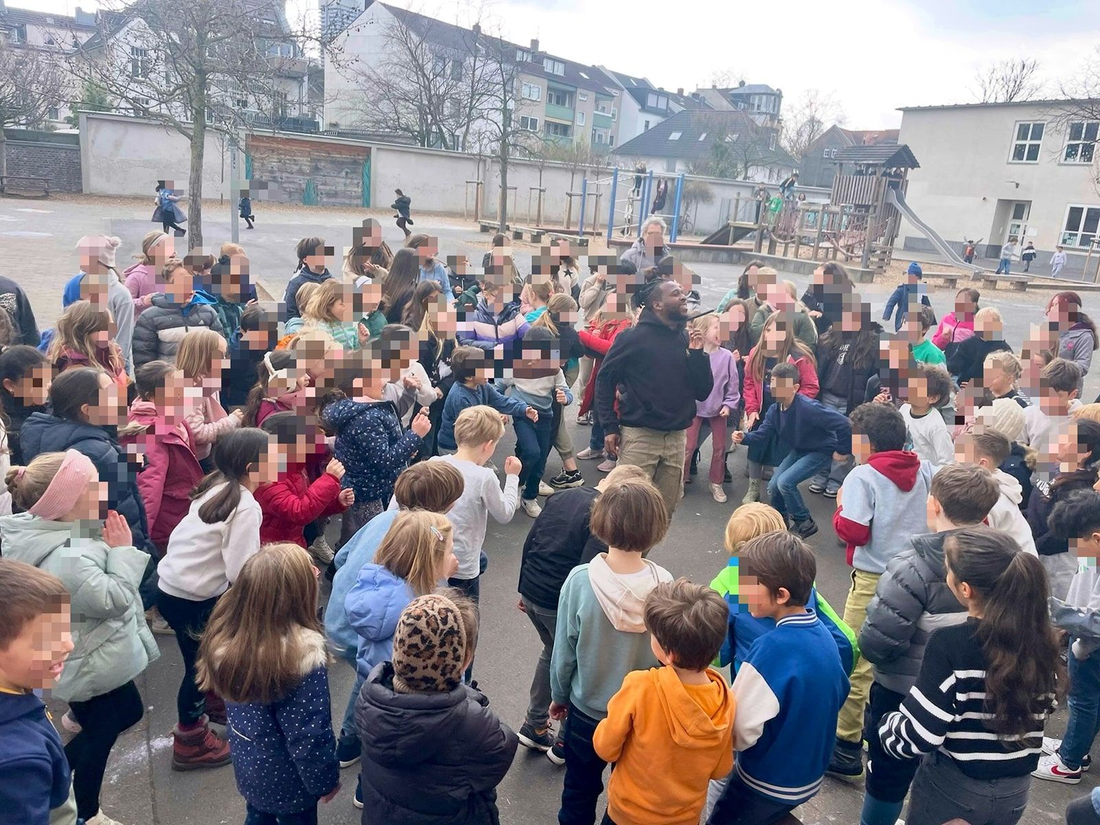 Kinder und Tänzer tanzen auf dem Schulhof